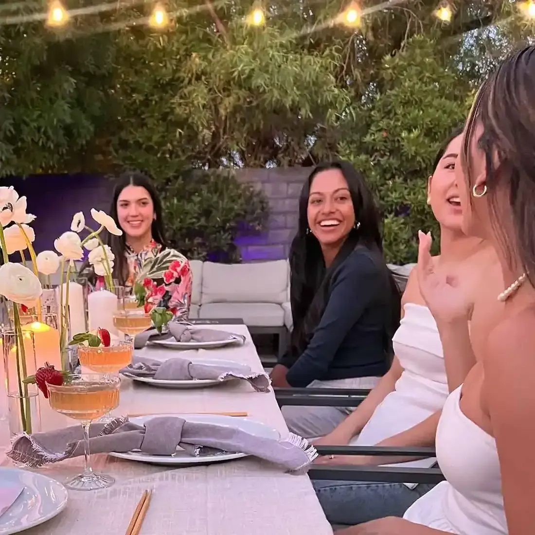 Guests seated around a candlelit table at a private chef dinner in Las Vegas