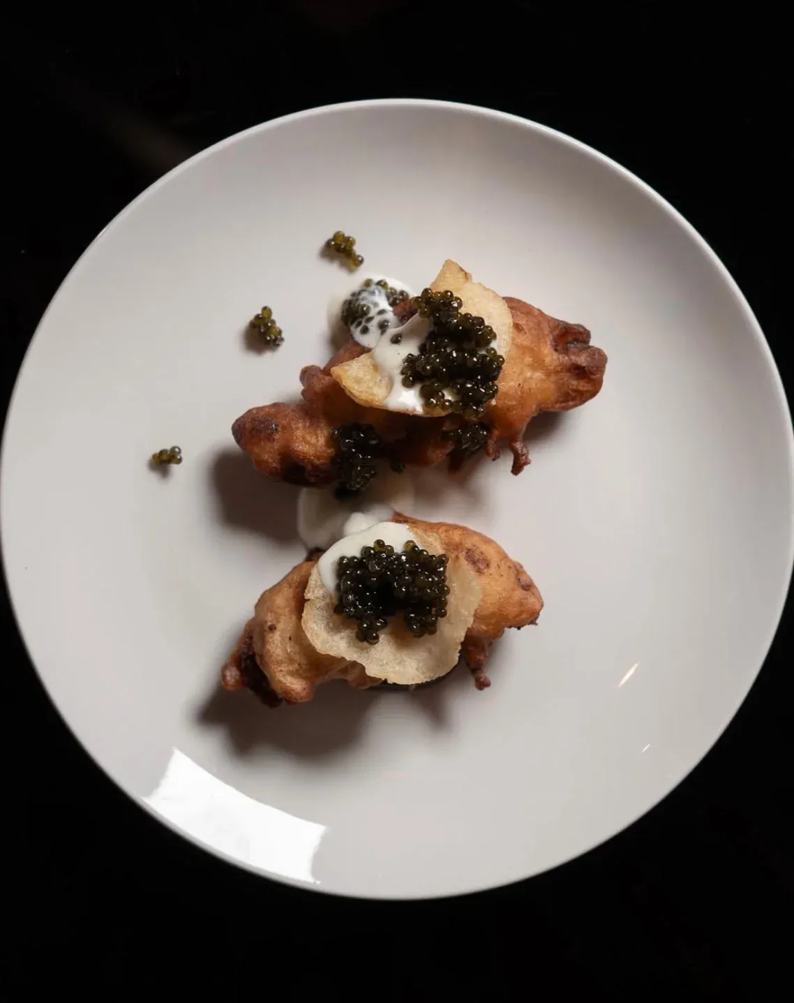 Overhead shot of foie gras dino nuggets with caviar by a Las Vegas private chef