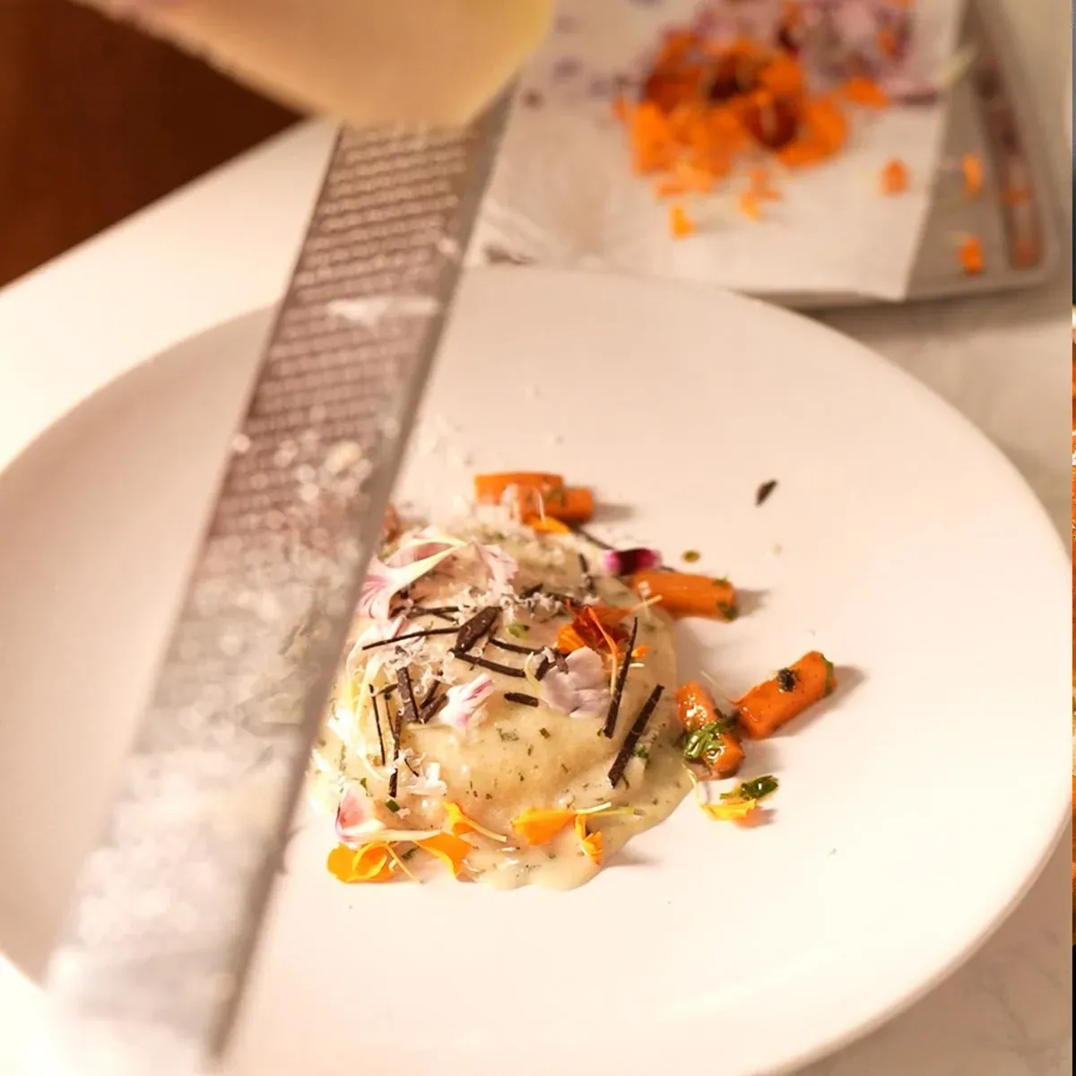 Part-time private chef finishing raviolo with fresh parmesan in a Las Vegas home