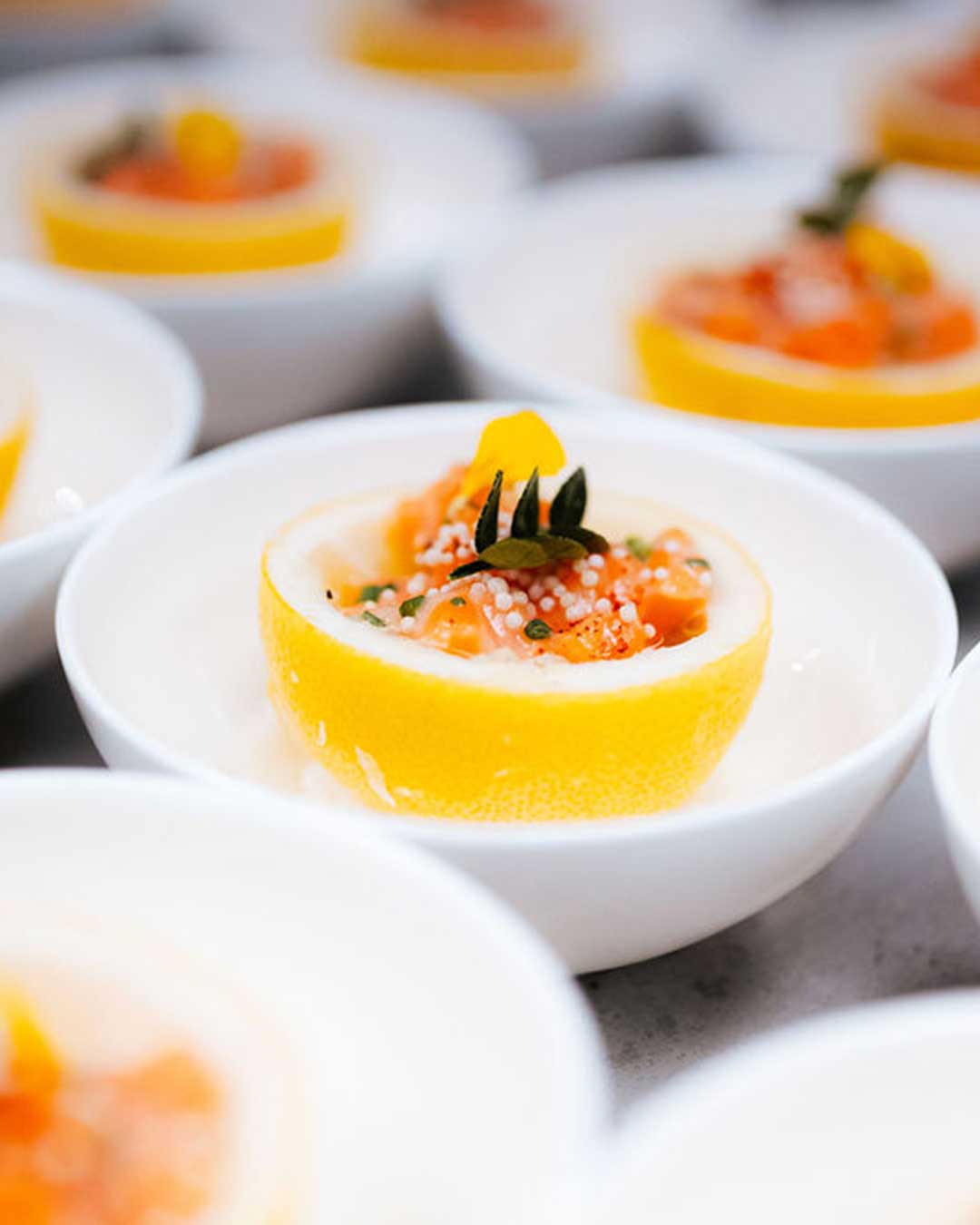 Salmon tartare amuse-bouche served in a hollowed lemon with citrus pearls at a Las Vegas private chef dinner